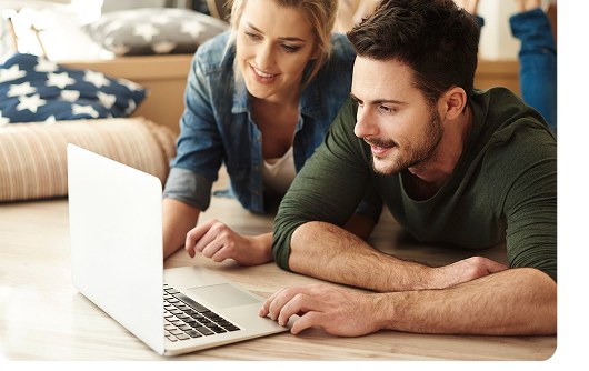 Couple reviewing documents on a laptop